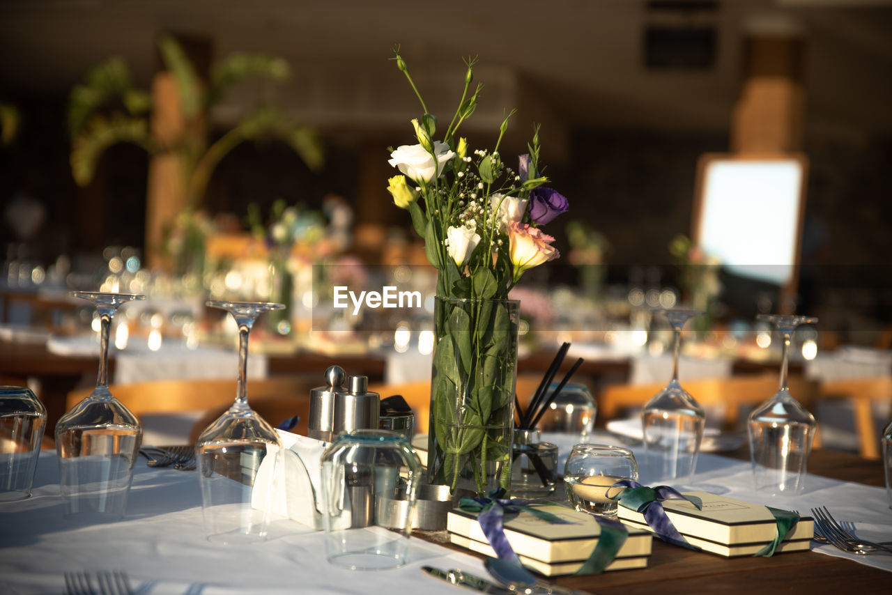 Flower vase on table in restaurant