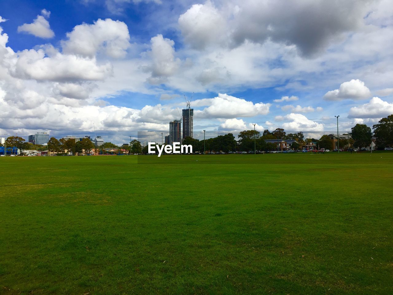 Scenic view of grassy field against cloudy sky