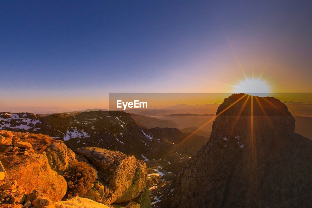 Scenic view of mountains against sky during sunset