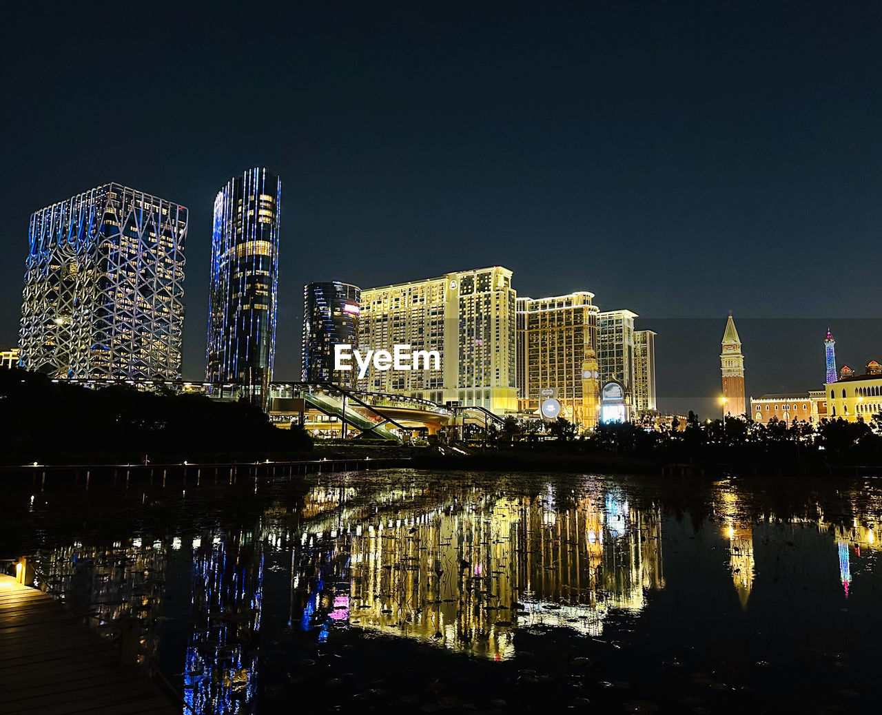 reflection of illuminated buildings in city at night