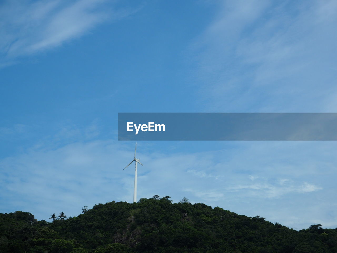 LOW ANGLE VIEW OF WINDMILLS AGAINST SKY