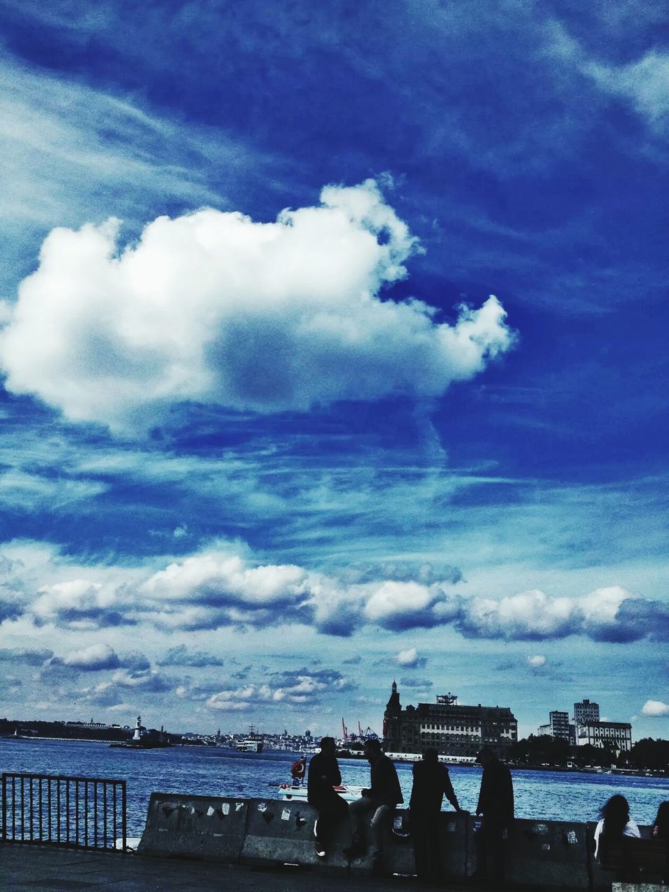 PEOPLE ON BEACH AGAINST SKY