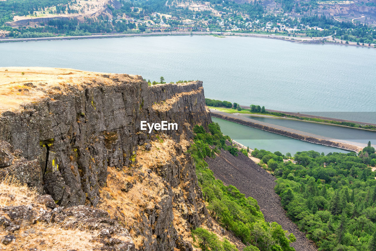 High angle view of river by cliff against sky