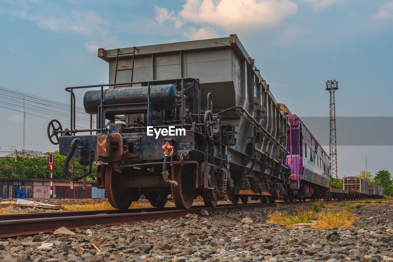 TRAIN IN RAILROAD TRACKS AGAINST SKY