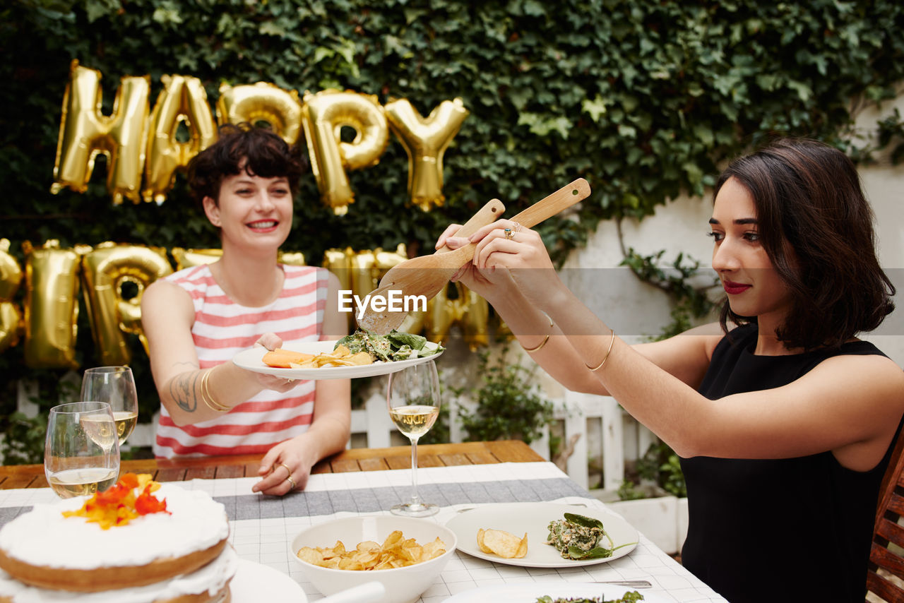 young woman having food at table