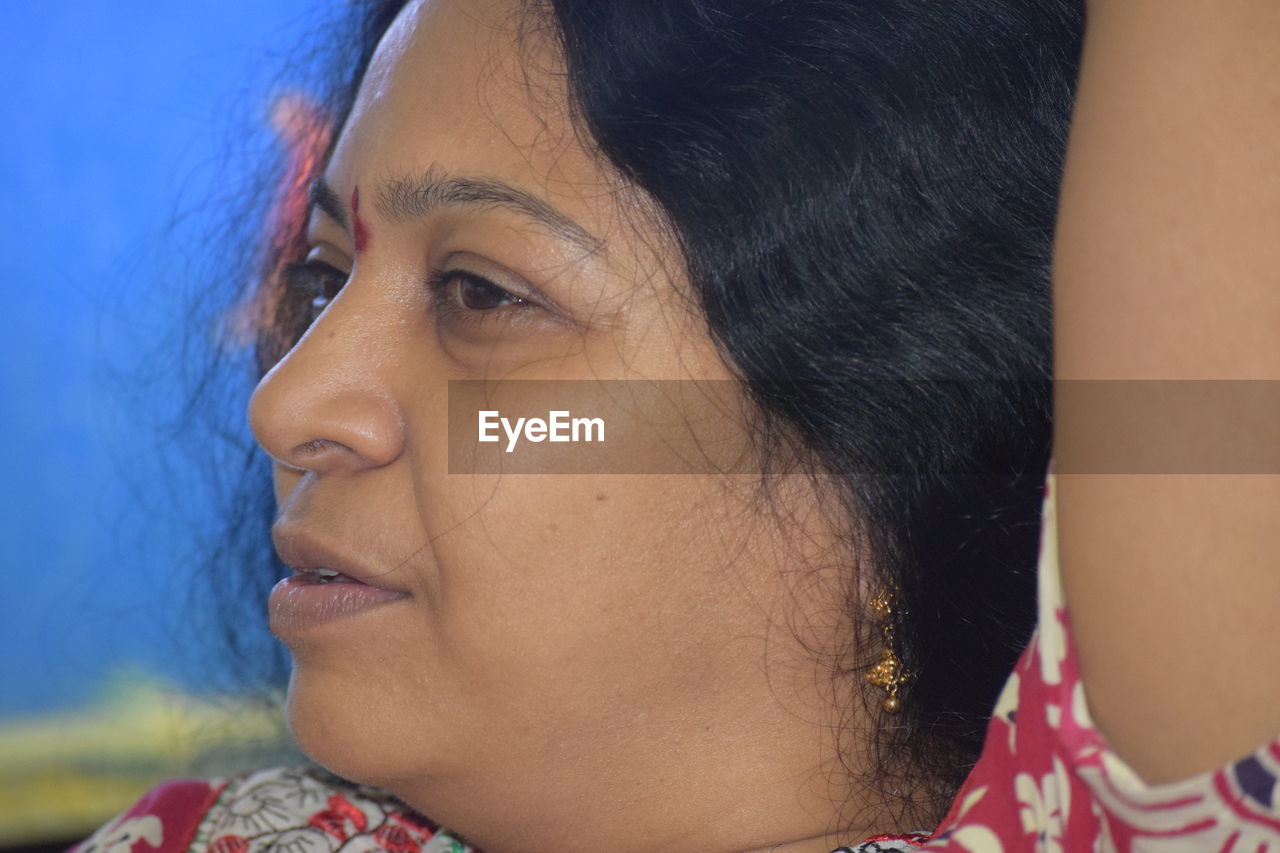 Close-up of smiling woman looking away