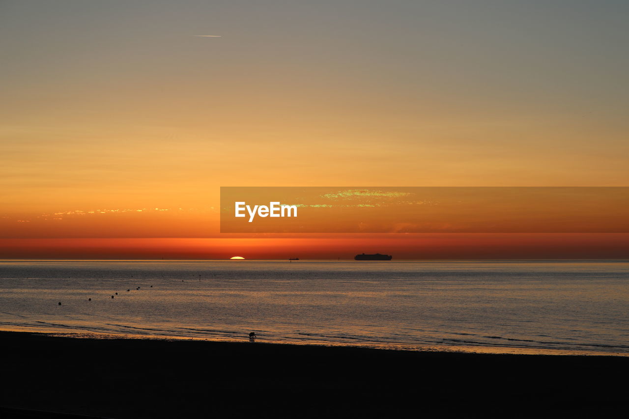 SCENIC VIEW OF SUNSET OVER SEA