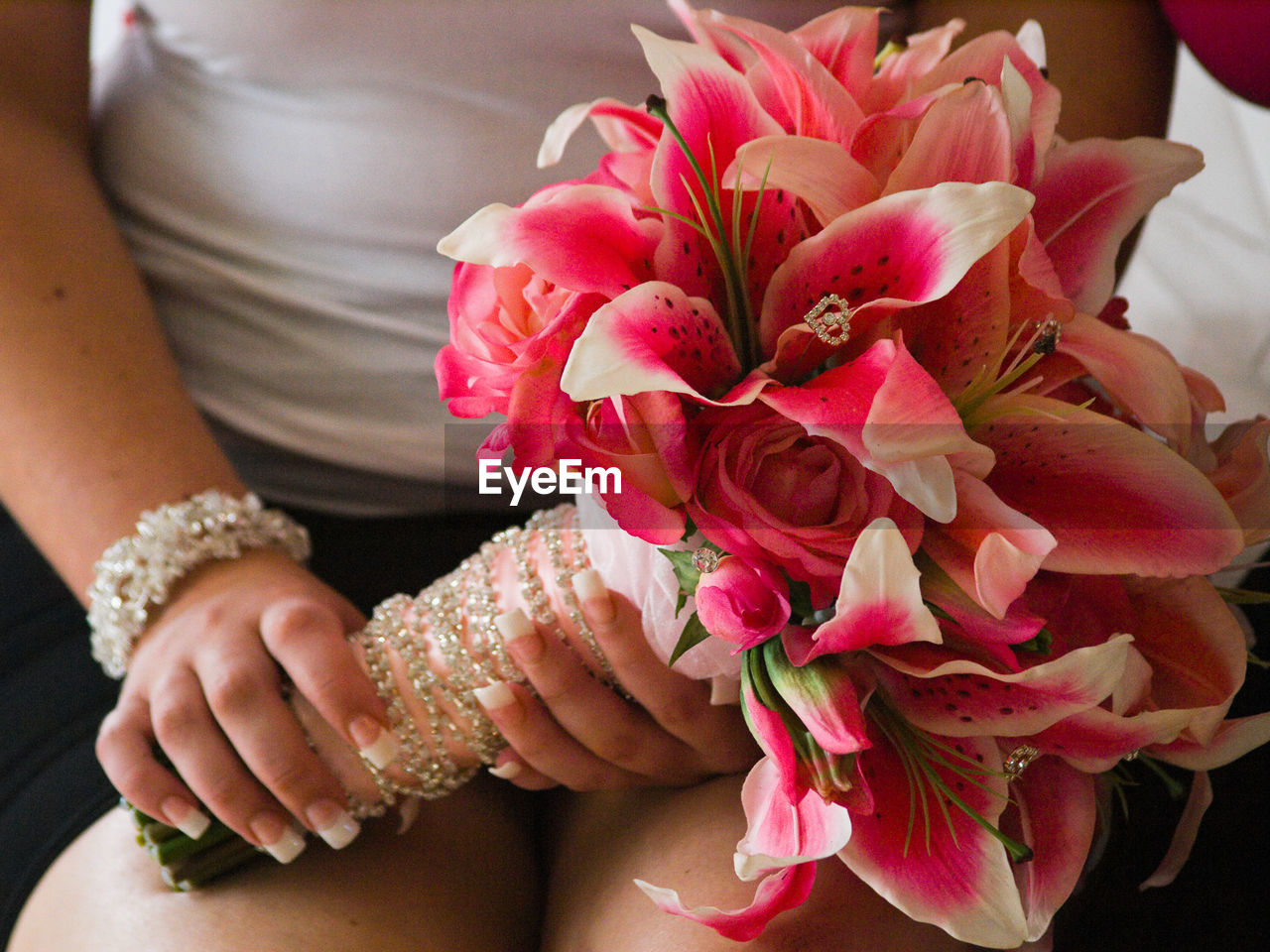 Midsection of bridesmaid holding bouquet