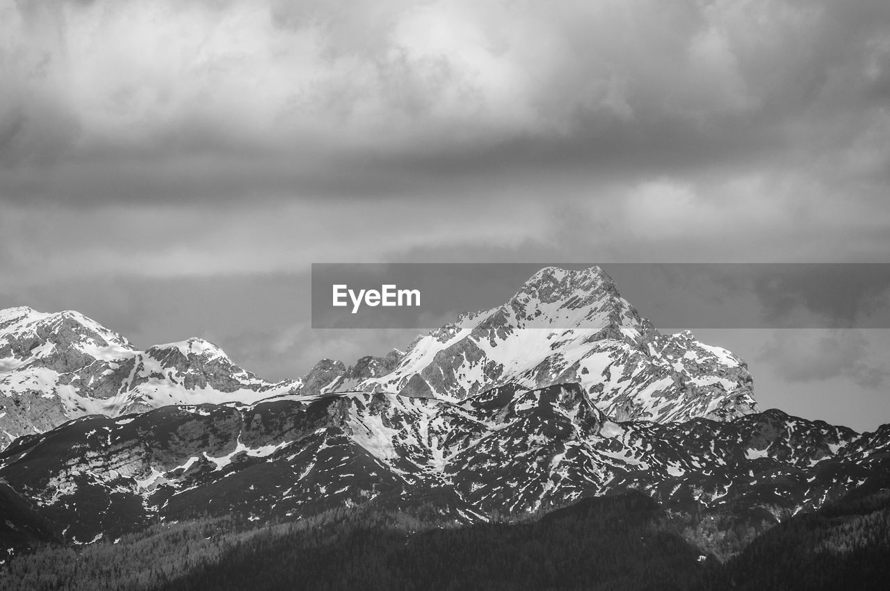 Scenic view of snow covered mountains against sky