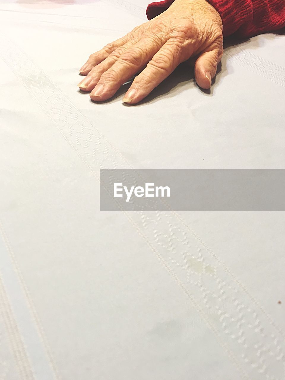 CLOSE UP OF WOMAN'S HAND ON SAND