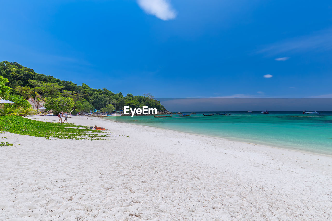 Scenic view of beach against blue sky