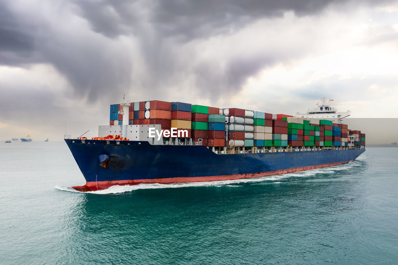 Container ship sailing to transport goods in containers for import export internationally 
