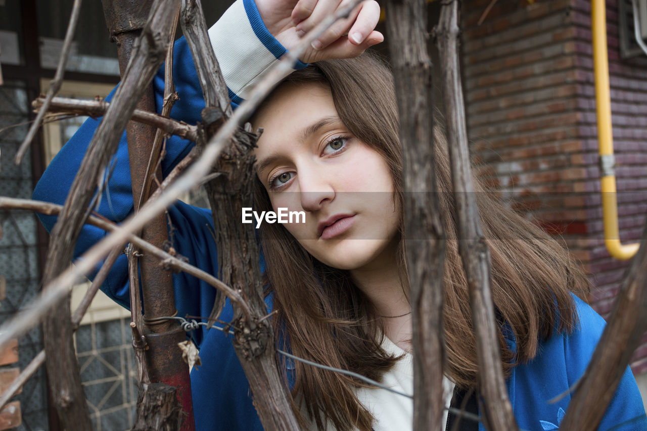 Portrait of girl by branch