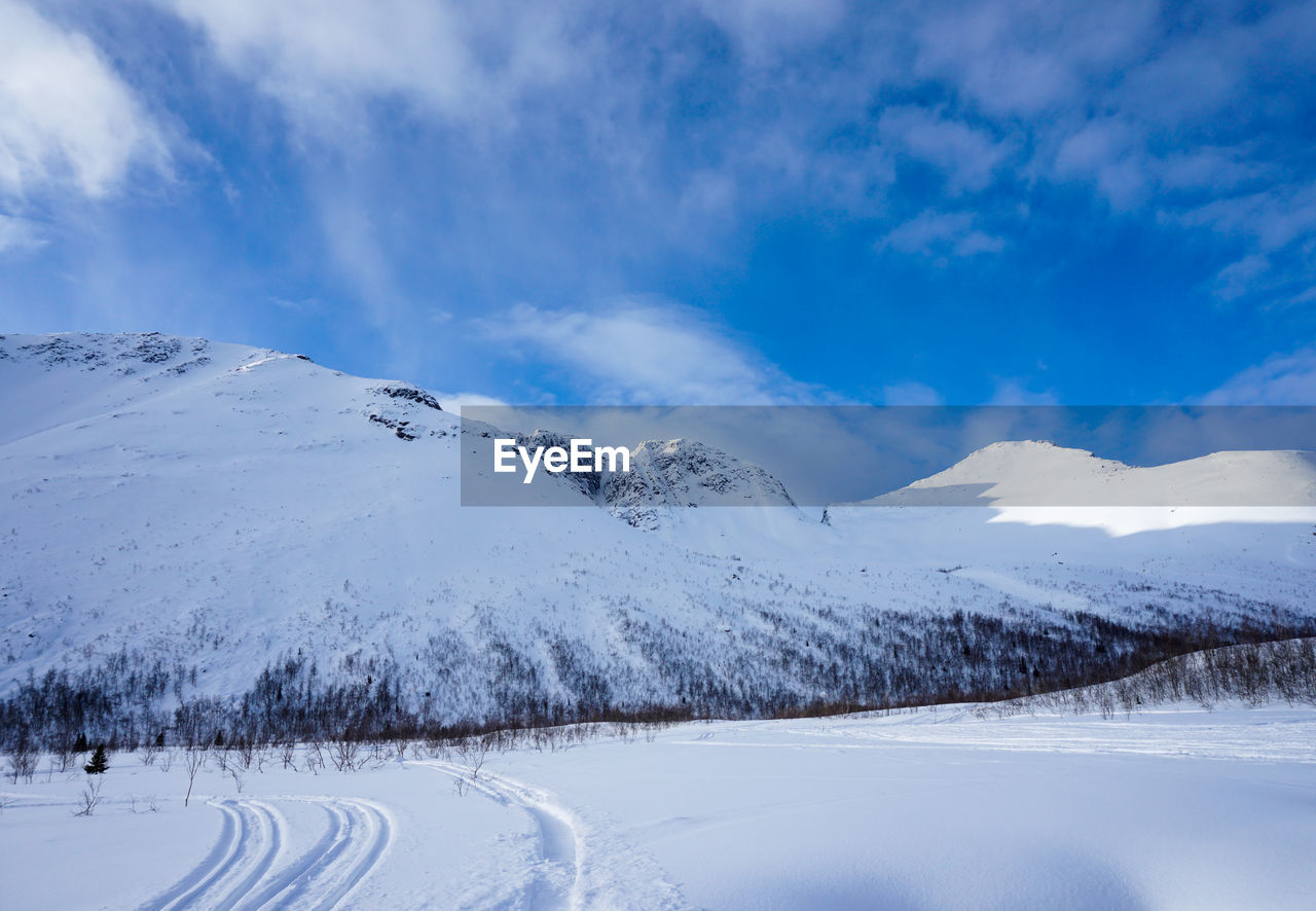 SNOWCAPPED LANDSCAPE AGAINST SKY