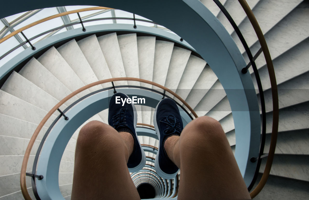 Low section of man on spiral staircase