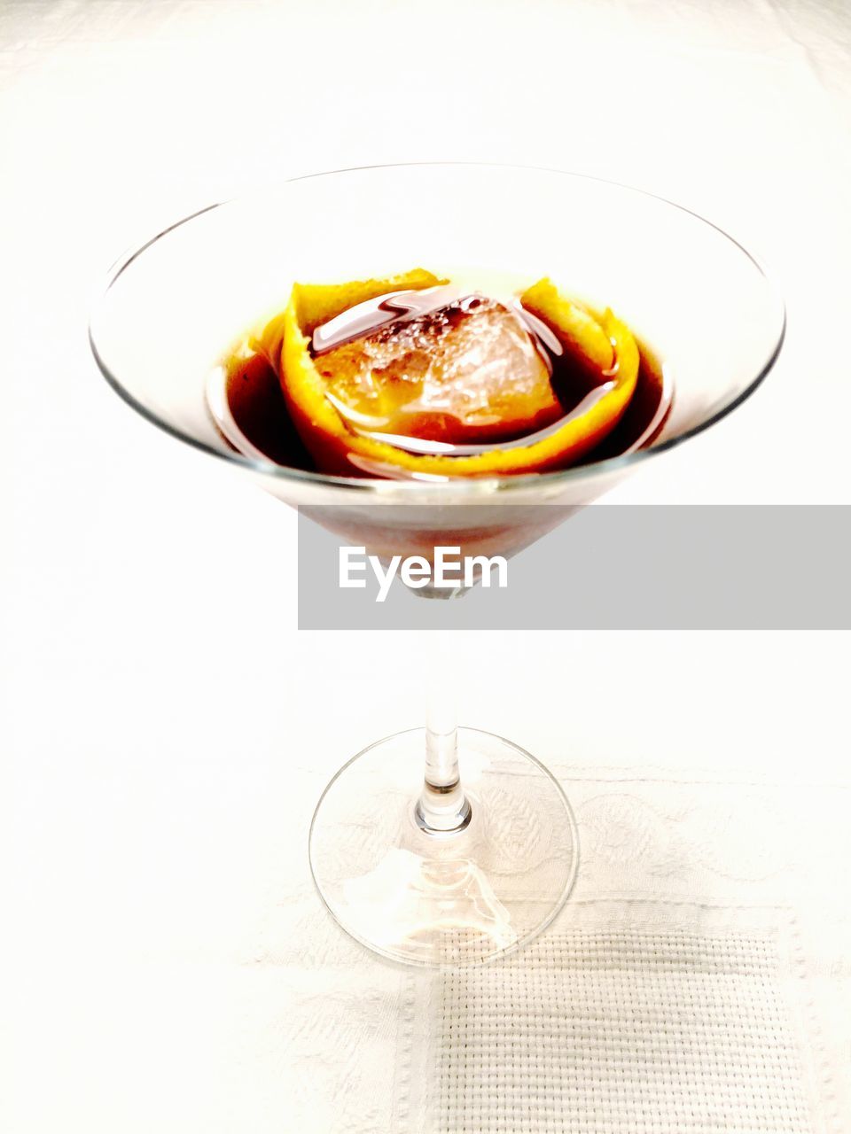 Close-up of cocktail in martini glass against white background