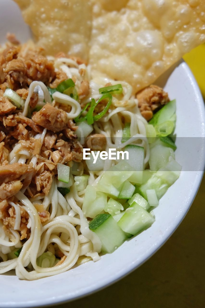 High angle view of chicken noodles served in bowl on table