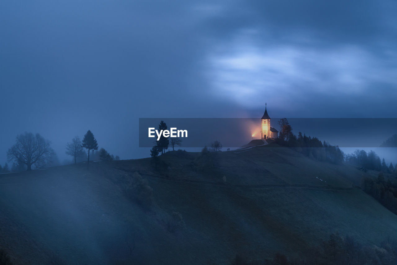 low angle view of rock formations against sky at night