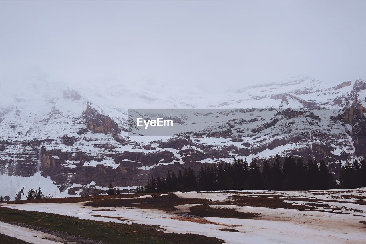 Snow covered landscape against sky