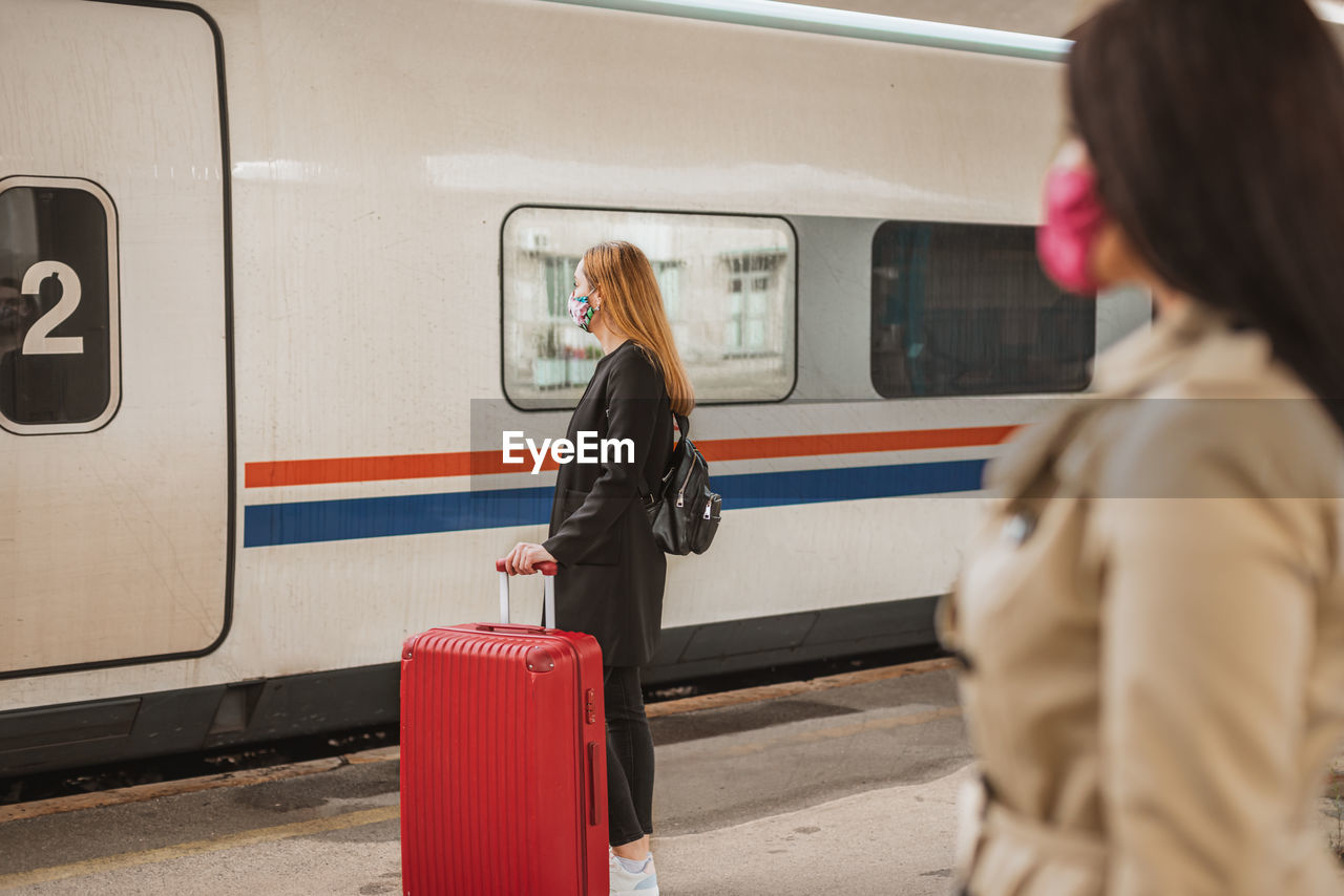 Rear view of woman on train at railroad station