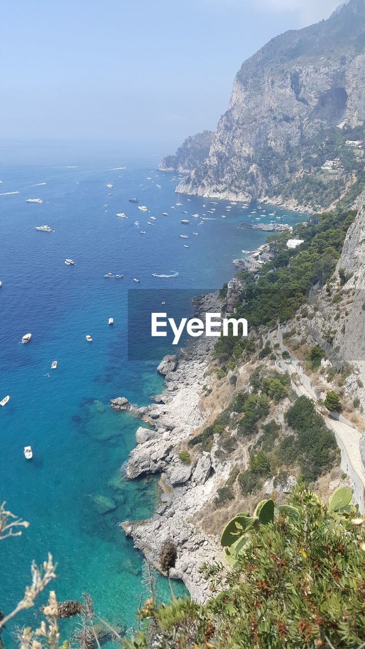 High angle view of sea and mountains against sky