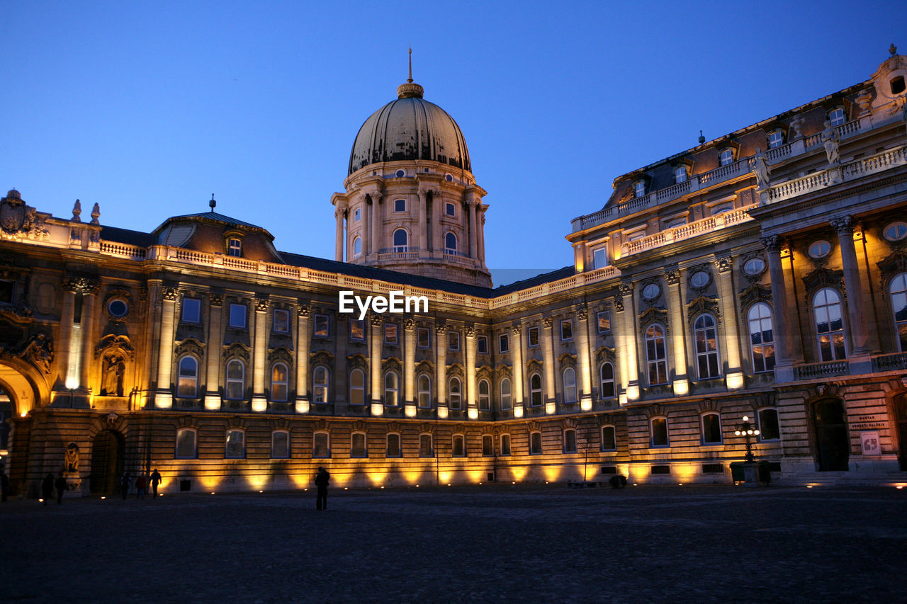 BUILDING AGAINST SKY AT DUSK