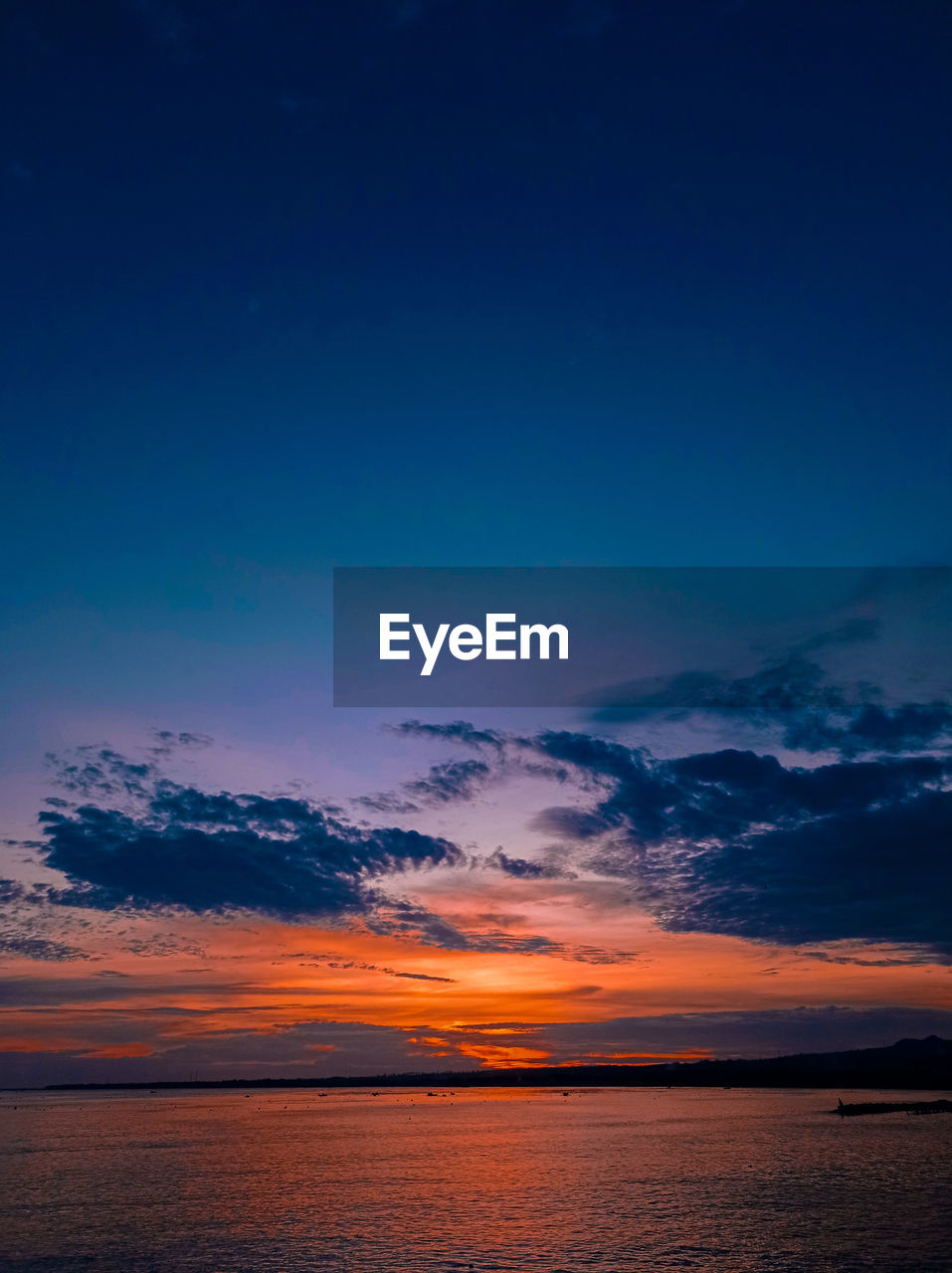 Scenic view of sea against romantic sky at sunset