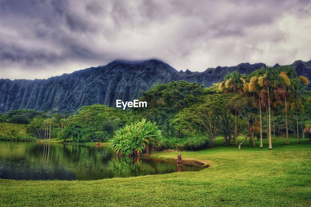 Scenic view of lake and mountains against sky