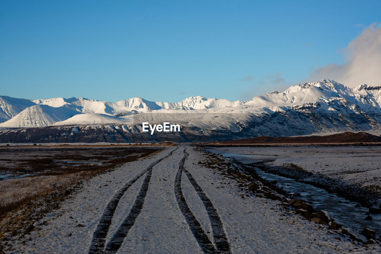 Scenic view of snowcapped mountains against sky