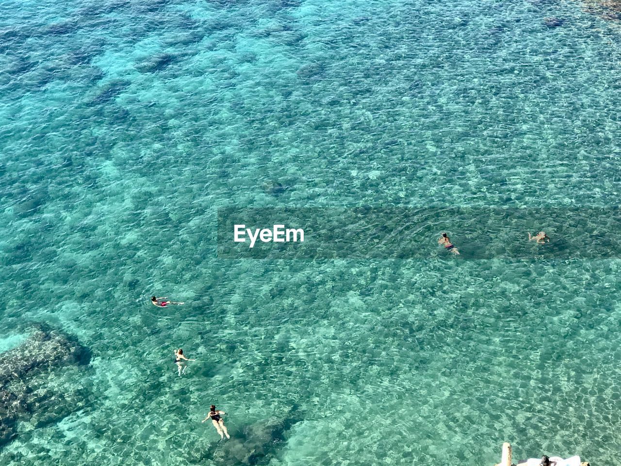 Aerial view of people swimming in sea