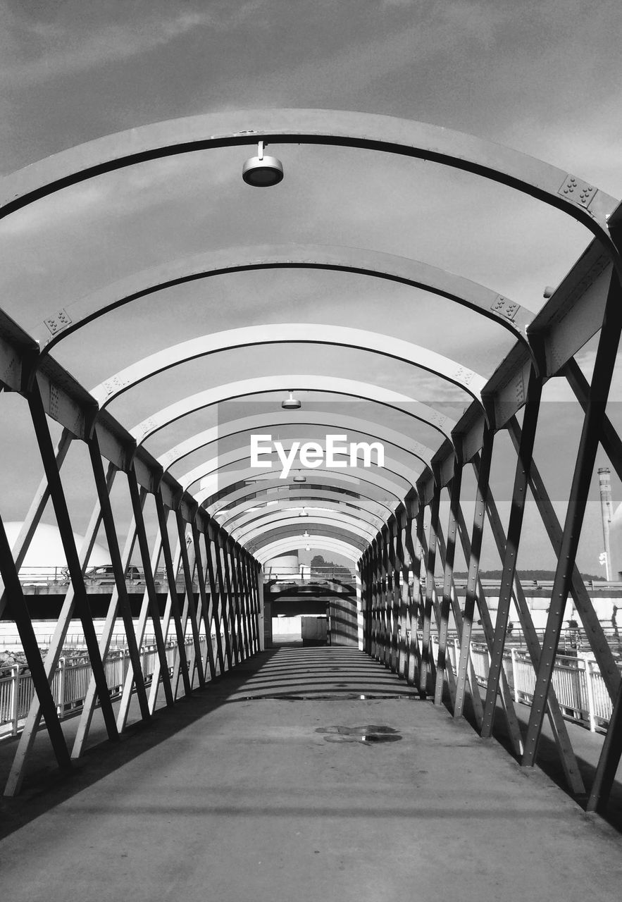 VIEW OF BRIDGE IN EMPTY CORRIDOR
