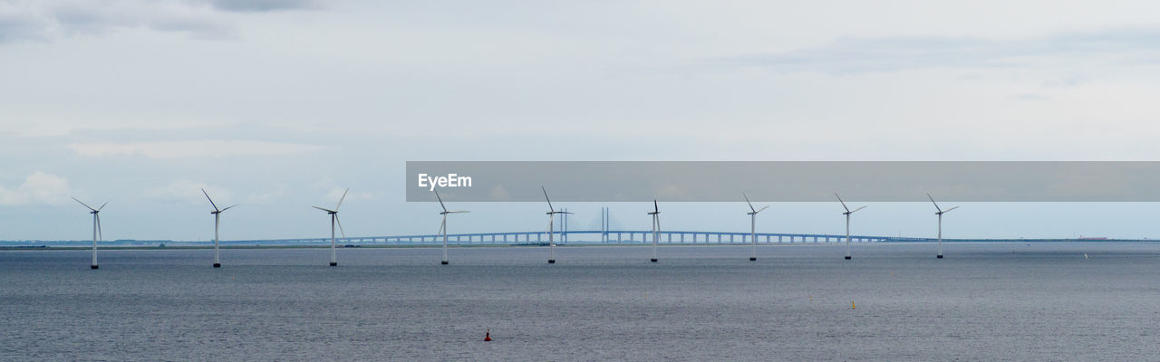 PANORAMIC VIEW OF WIND TURBINES AGAINST SKY