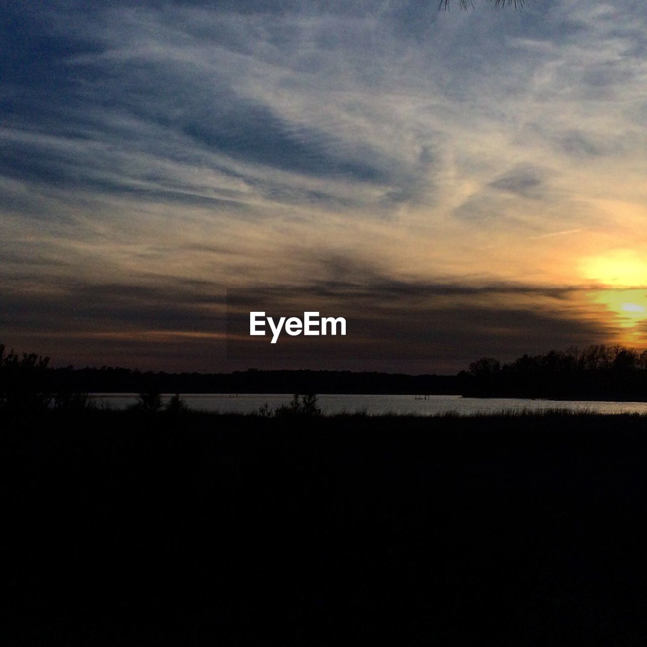 SCENIC VIEW OF SUNSET OVER RIVER