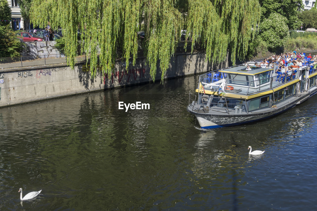 BOAT MOORED IN RIVER