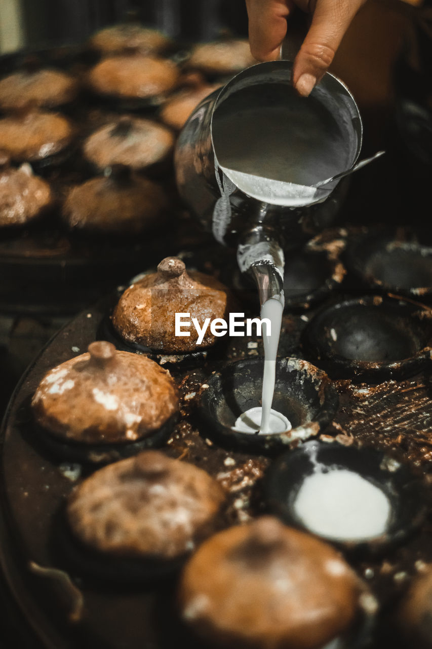 Cropped hands of woman preparing food in kitchen