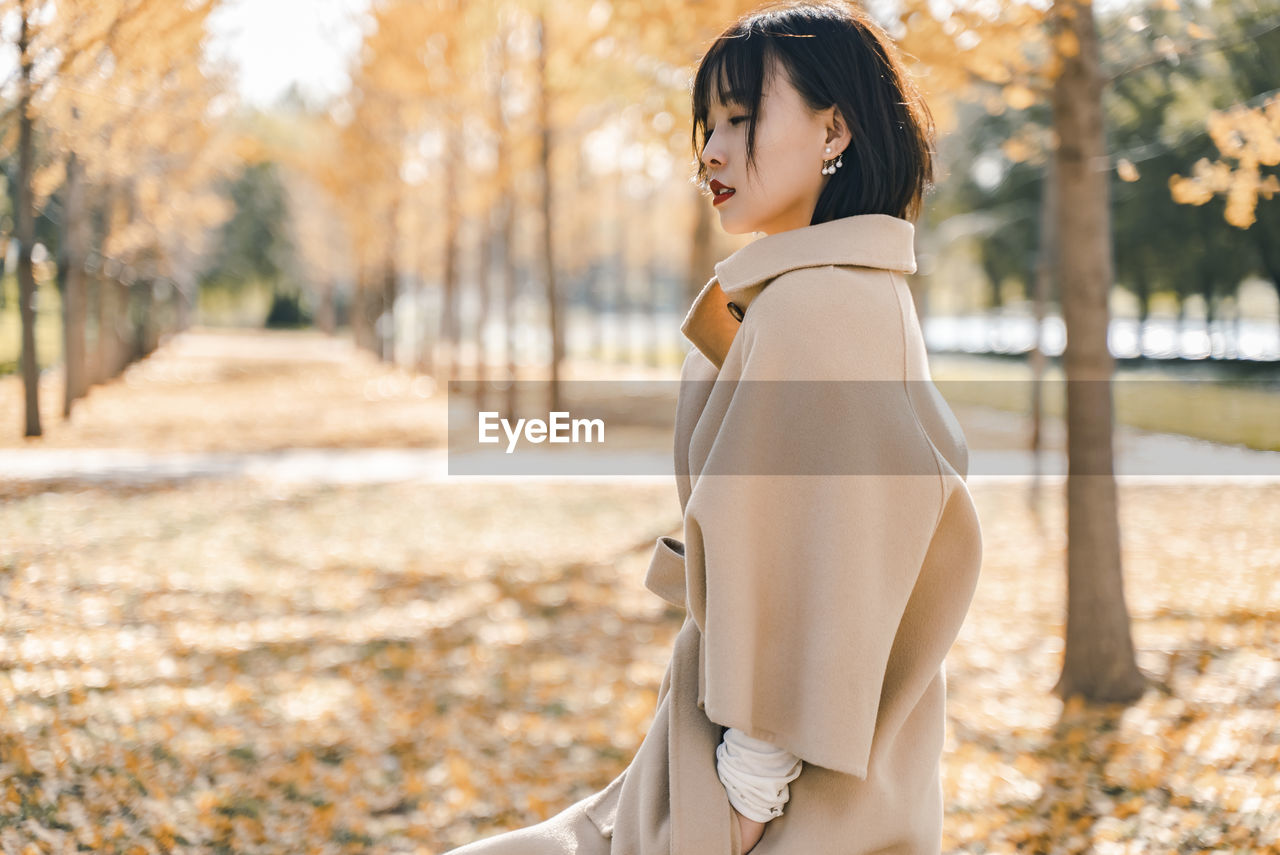 Side view of woman standing at park