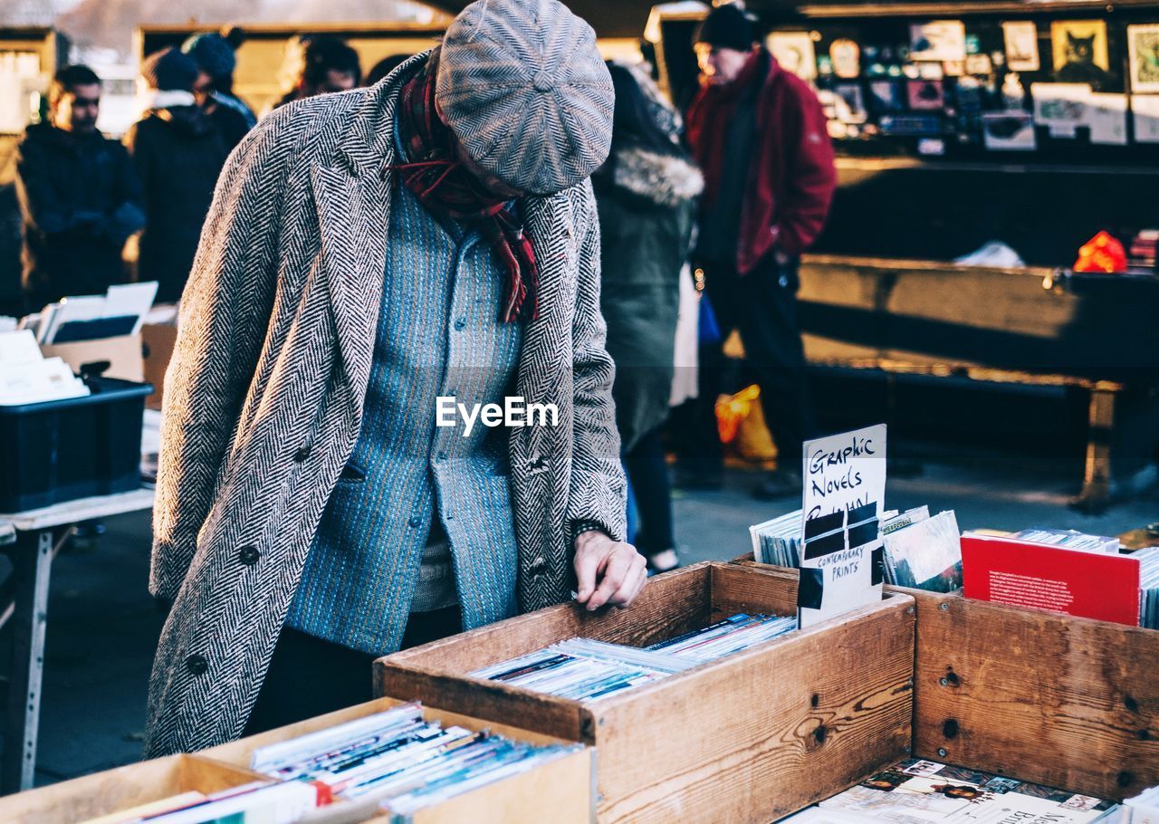 PEOPLE STANDING IN MARKET DURING WINTER AT STREET