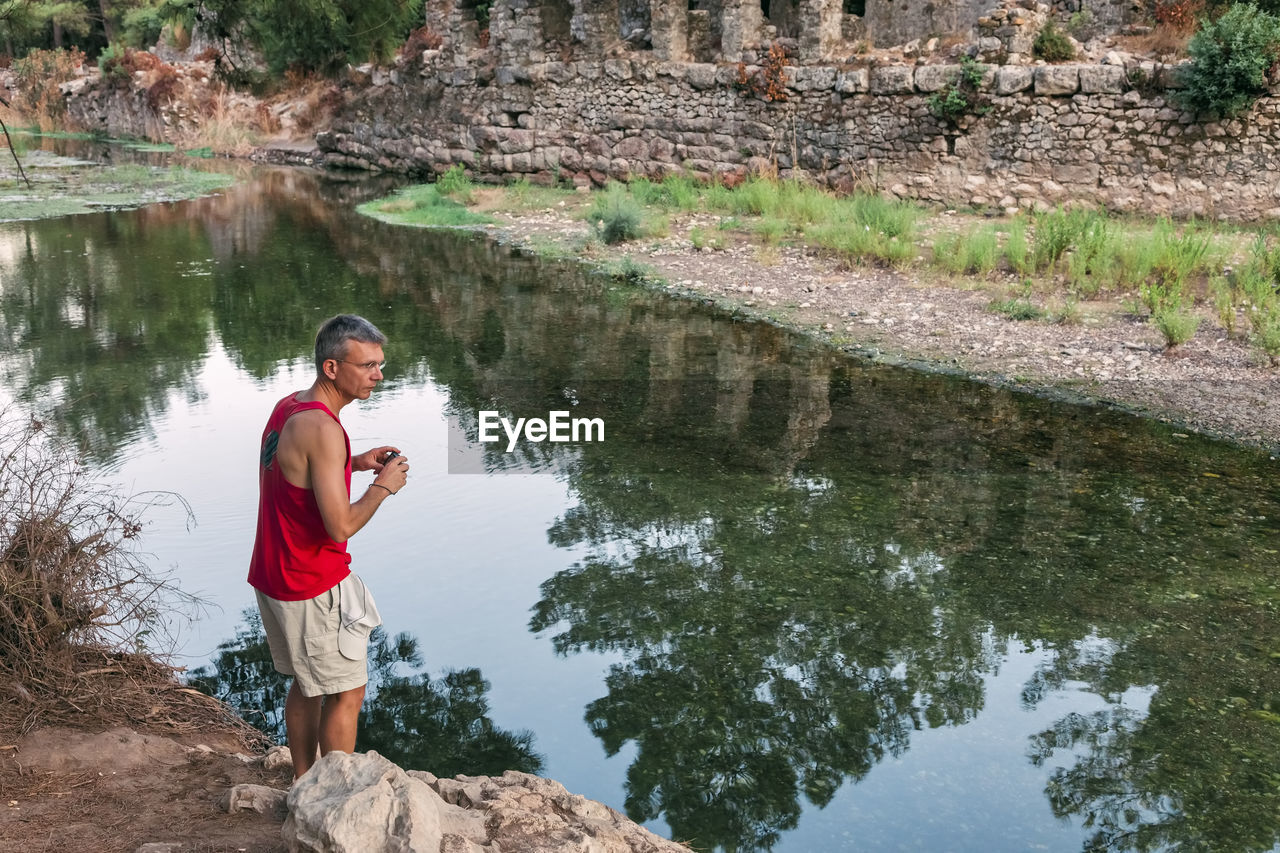 Man standing against lake