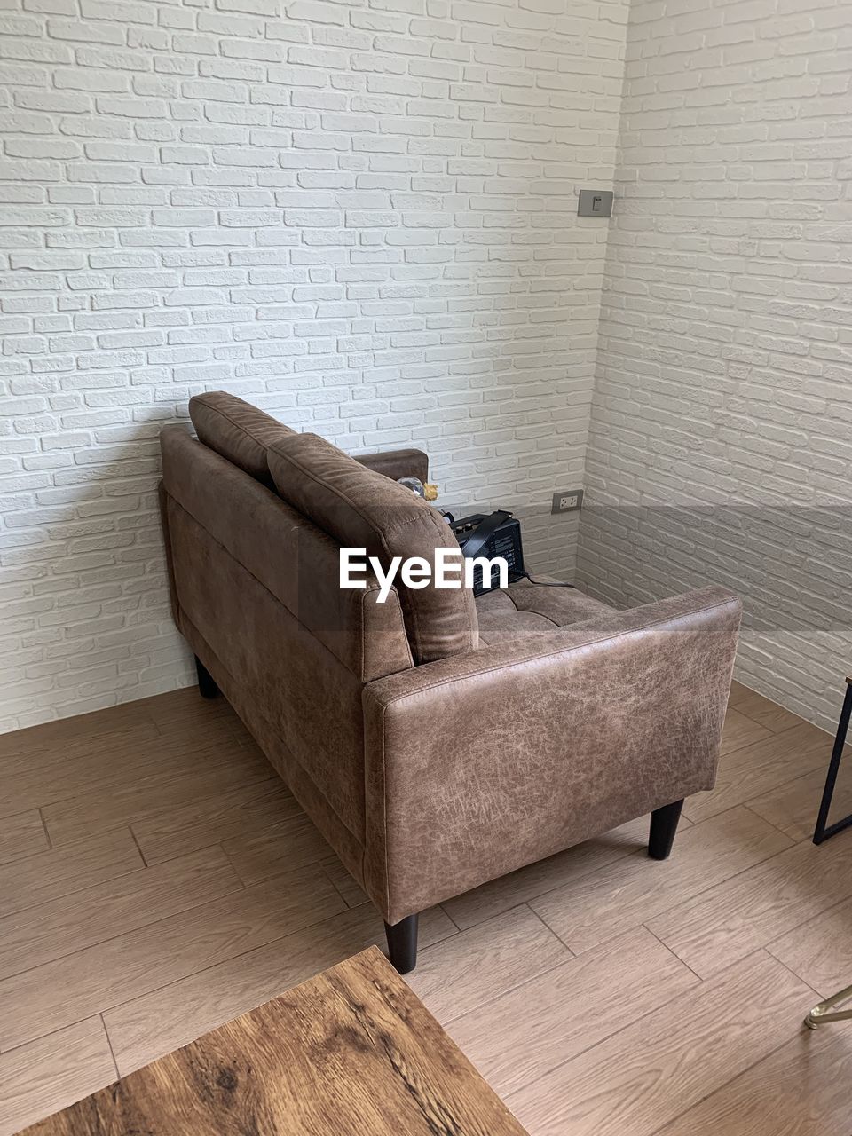 VIEW OF SOFA ON FLOOR AGAINST WALL