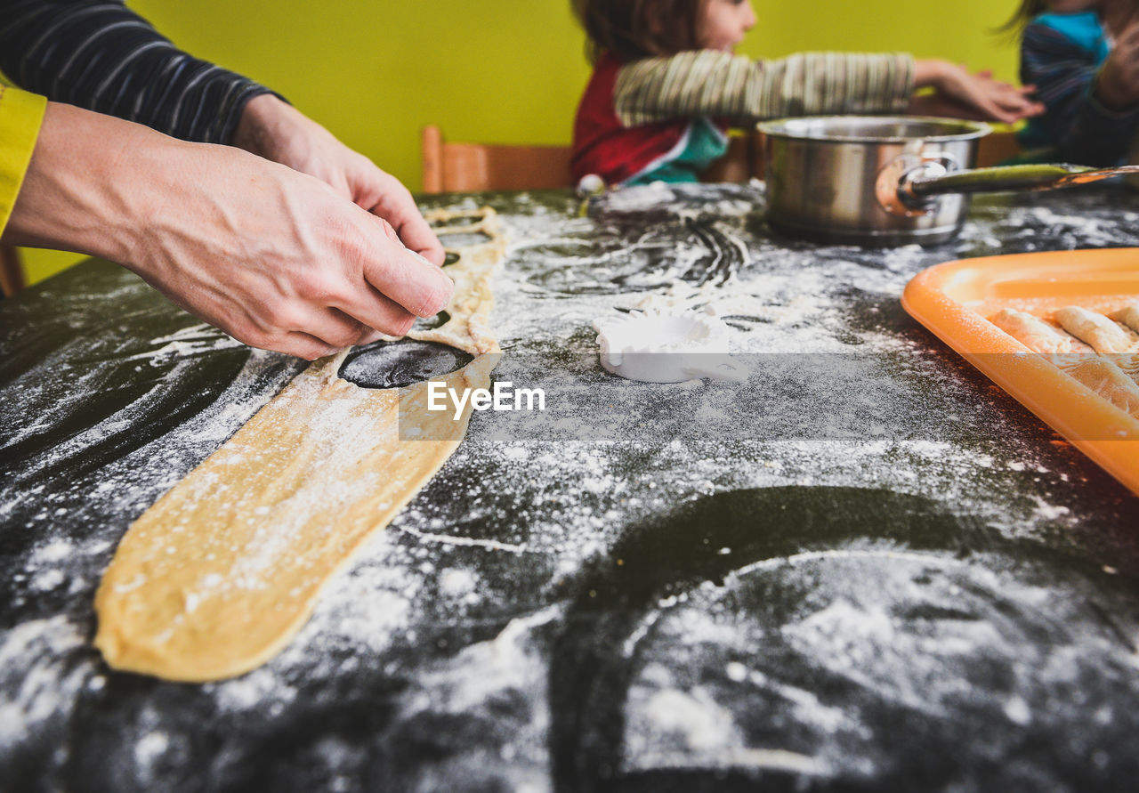 Cropped image of woman preparing ravioli on table