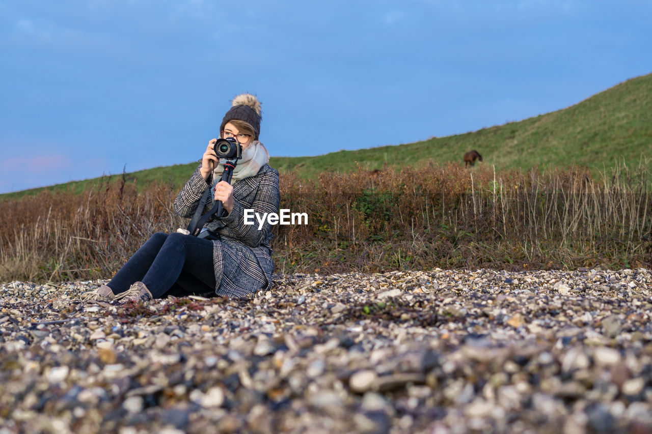 MAN PHOTOGRAPHING CAMERA