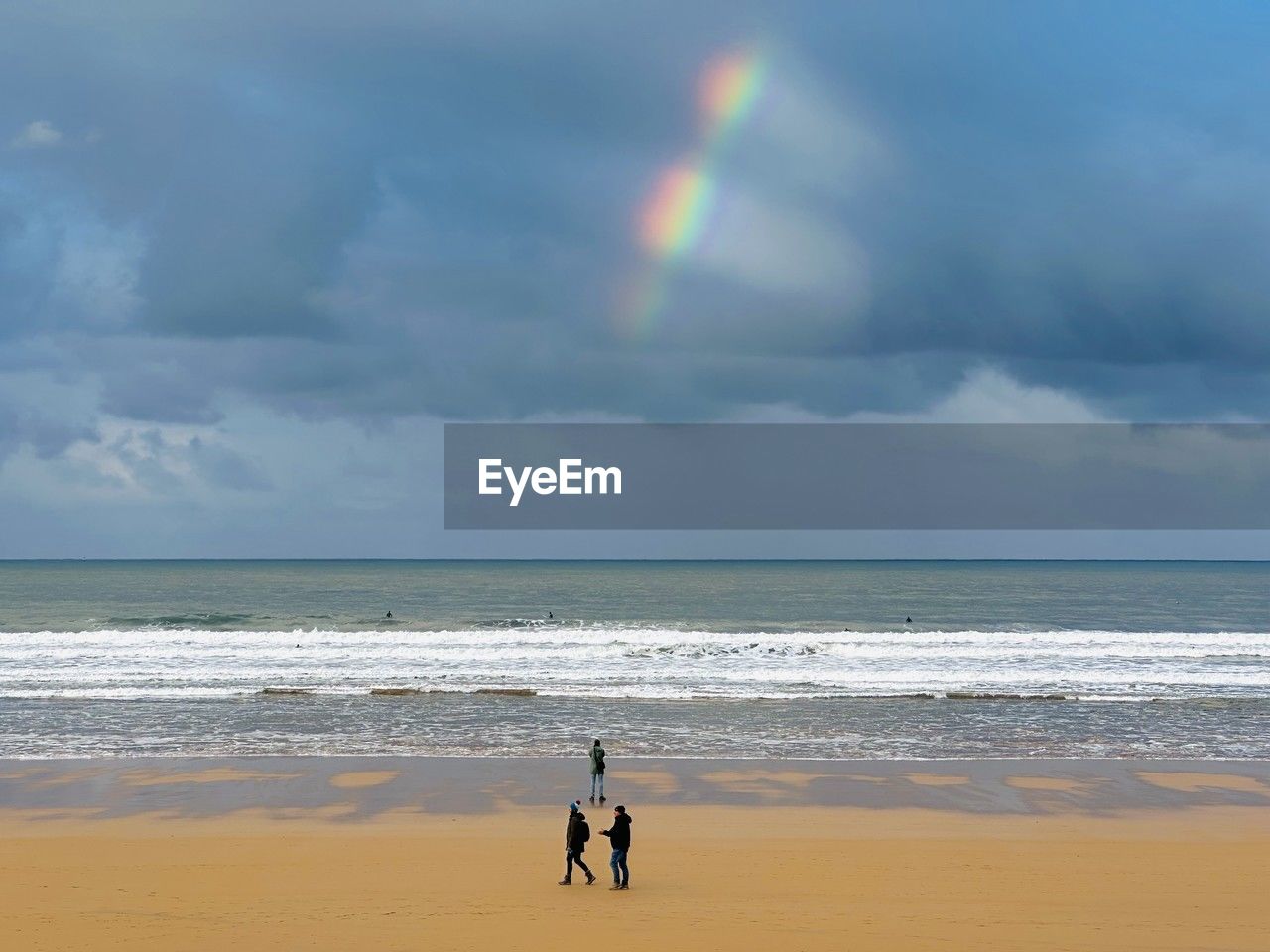 sea, beach, water, sky, land, horizon over water, cloud, horizon, ocean, beauty in nature, wave, rainbow, body of water, nature, scenics - nature, sand, wind wave, coast, shore, motion, full length, tranquility, day, wind, idyllic, holiday, men, tranquil scene, vacation, leisure activity, outdoors, trip, storm, two people, child, wet, environment, childhood, surfing, sports, togetherness, overcast, lifestyles