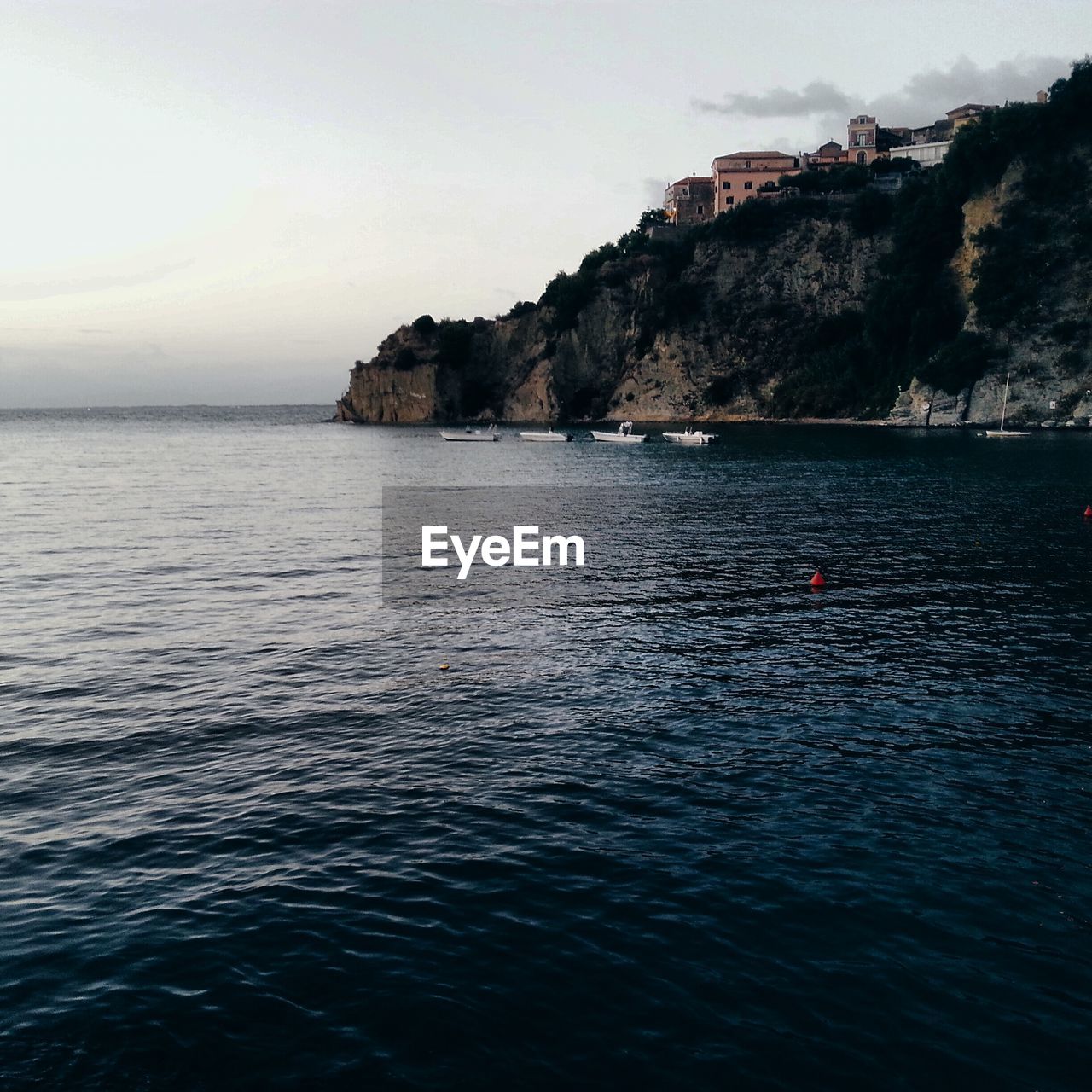 SCENIC VIEW OF SEA WITH MOUNTAINS IN BACKGROUND