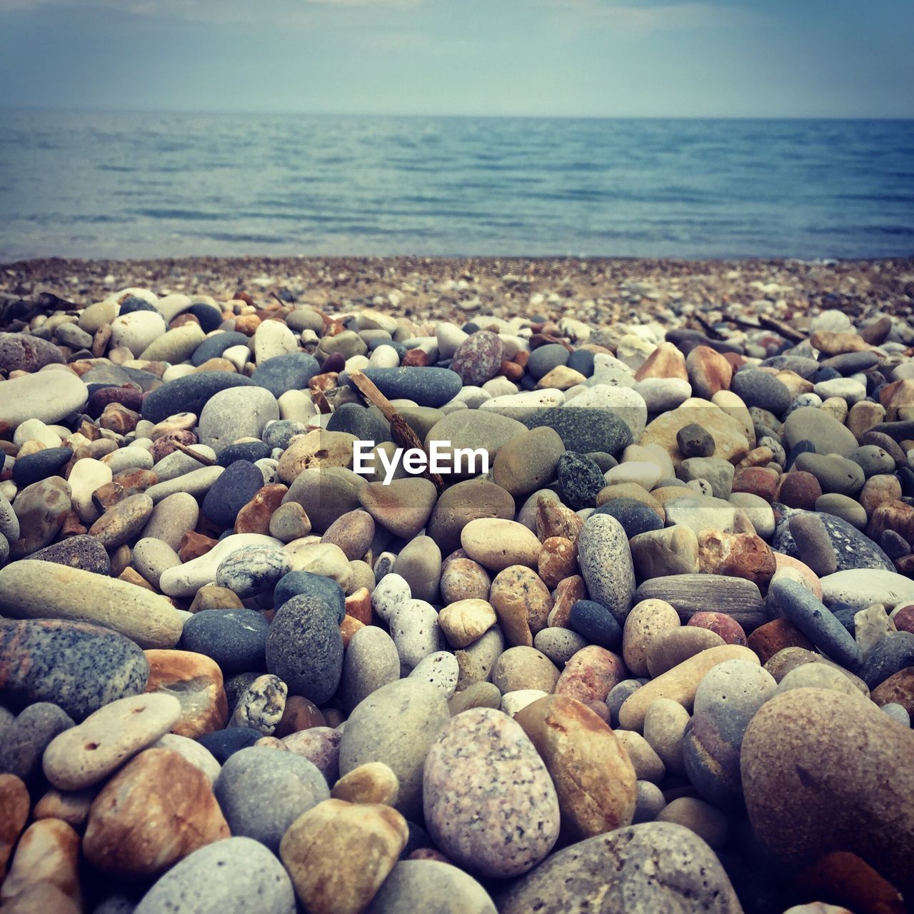 Pebbles on beach against sky