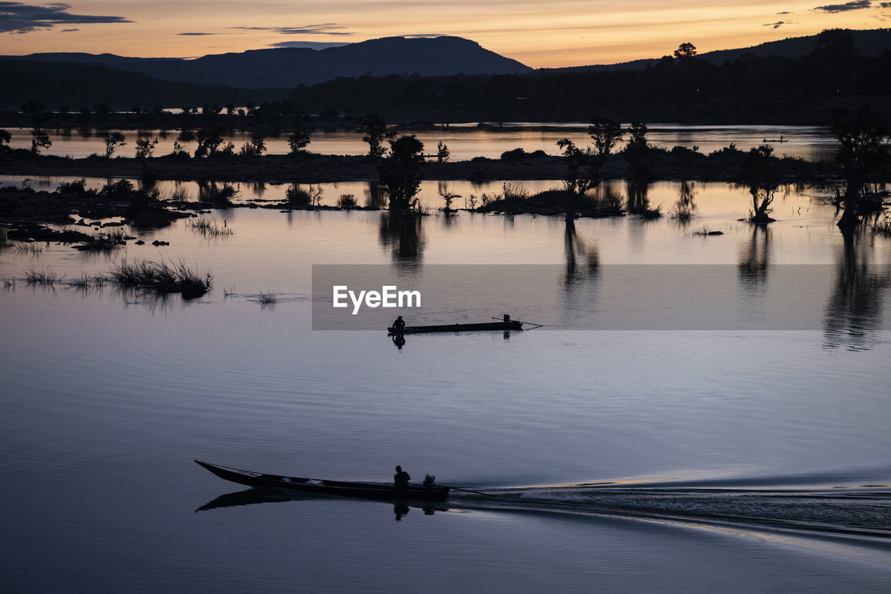 scenic view of lake against sky during sunset