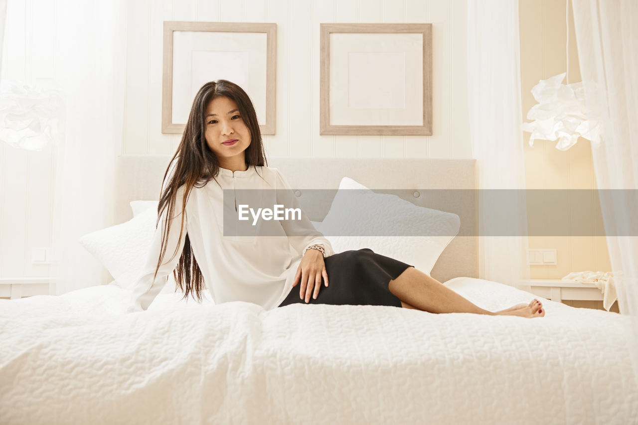 Business woman relaxing on bed at luxury hotel in iceland