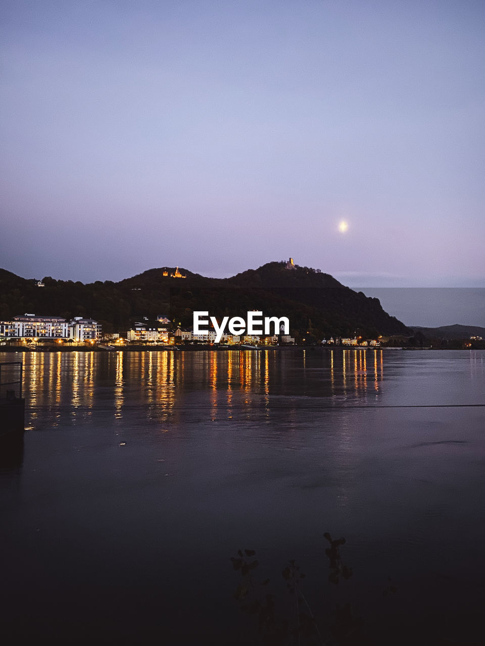 SCENIC VIEW OF ILLUMINATED MOUNTAINS AGAINST SKY AT SUNSET