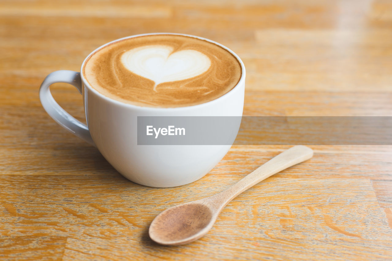 COFFEE CUP WITH SPOON ON TABLE