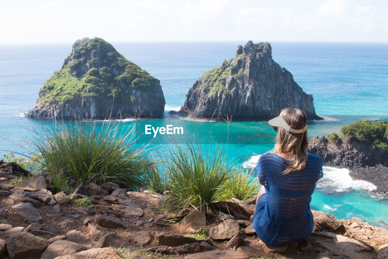 Rear view of woman looking at sea against sky