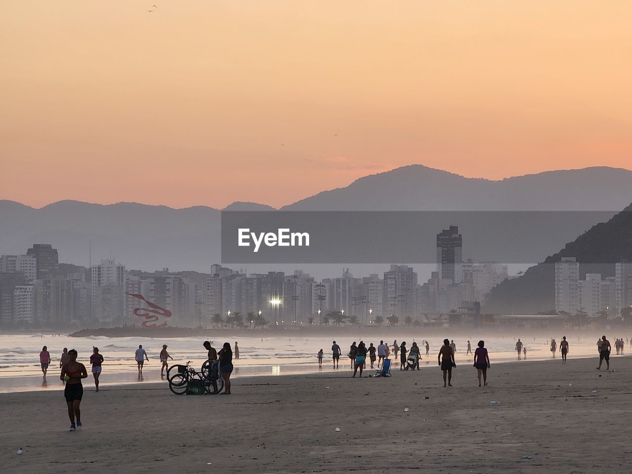 horizon, morning, sky, architecture, land, city, dawn, water, crowd, sunrise, nature, body of water, mountain, sea, group of people, coast, landscape, beach, travel destinations, building exterior, built structure, travel, large group of people, environment, sun, skyline, beauty in nature, building, lifestyles, shore, scenics - nature, tourism, holiday, outdoors, vacation, fog, trip, cityscape, cloud, urban skyline, silhouette, leisure activity, ocean, city life, twilight, bay